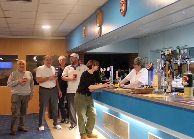 People enjoying a drink at the clubs bar